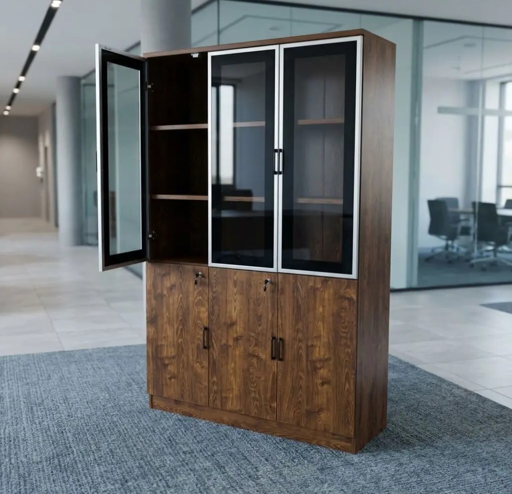 3-Door Wooden Office Cabinet (73) Nairobi Office Mart Wooden Office Cabinet Prices In Kenya 3-Door Wooden Office Cabinet – Stylish, Spacious & Functional Storage Keep your workspace neat and organized with the 3-Door Wooden Office Cabinet. Designed for modern offices, it combines practical storage with a professional appearance. Its wooden finish adds warmth and elegance to your office interior. Therefore, it is an excellent choice for corporate offices, home offices, and business environments. The 3-door office cabinet provides convenient storage for documents, files, stationery, and other office essentials. Its multiple doors help keep your belongings neatly arranged and out of sight. As a result, you can maintain a clean and clutter-free workspace. It is ideal for professionals who need accessible storage for everyday office supplies. Built for practical office organization, this wooden storage cabinet helps maximize available space. You can use it to store files, folders, books, and important paperwork. Furthermore, its versatile design makes it suitable for executive offices, administrative departments, reception areas, and meeting rooms. It also pairs well with executive desks and other wooden office furniture. The wooden office storage cabinet offers a professional look that complements different office layouts. Its three-door design provides a convenient way to organize items according to your needs. Additionally, the cabinet helps keep essential documents in one central location. This makes daily office activities easier and more efficient. Whether you are furnishing a new office or upgrading your existing workspace, the 3-Door Wooden Office Cabinet is a practical addition. Its combination of storage capacity, functionality, and timeless styling makes it suitable for various professional settings. Choose this cabinet to create a more organized and attractive working environment. Key Features Three-Door Design: Provides convenient access to stored office essentials. Spacious Storage: Ideal for files, folders, documents, stationery, and books. Wooden Finish: Adds a classic and professional touch to your office. Organized Workspace: Helps reduce clutter and keeps supplies neatly stored. Versatile Application: Suitable for corporate offices, home offices, and administrative spaces. Professional Appearance: Complements executive desks and other office furniture. Practical Functionality: Keeps everyday office essentials accessible and organized. Improve Your Office Organization Today Choose the 3-Door Wooden Office Cabinet for a practical and stylish storage solution. It helps maintain a tidy workspace while enhancing your office interior. Moreover, its versatile design makes it suitable for businesses of different sizes. Add this wooden office cabinet to your furniture collection and enjoy a more organized, professional working environment.